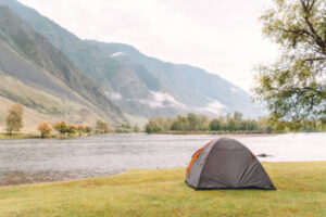 hiking tent on the beach of river. side view